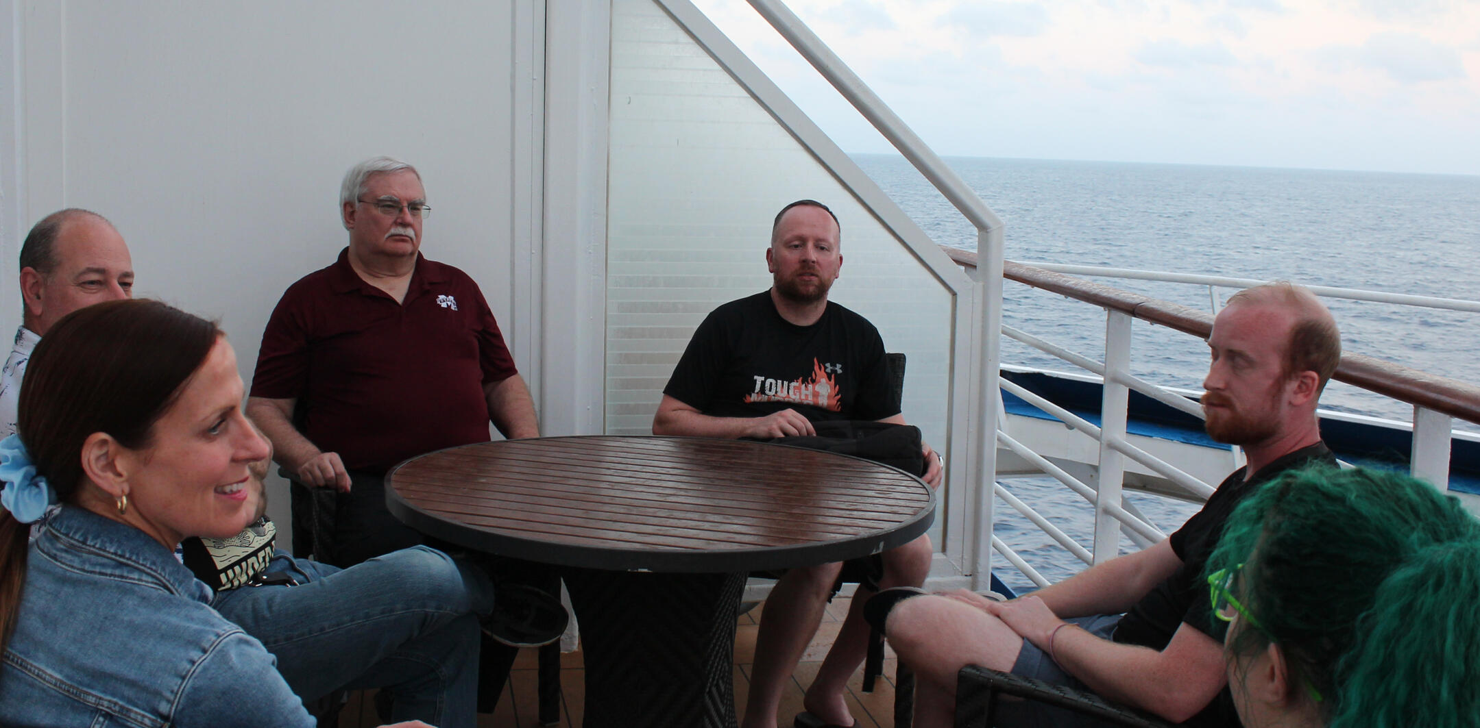 Writing by the Ocean A writer's laptop screen with a sun setting on open ocean behind it.